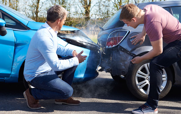 2 Guys looking at their crashed cars